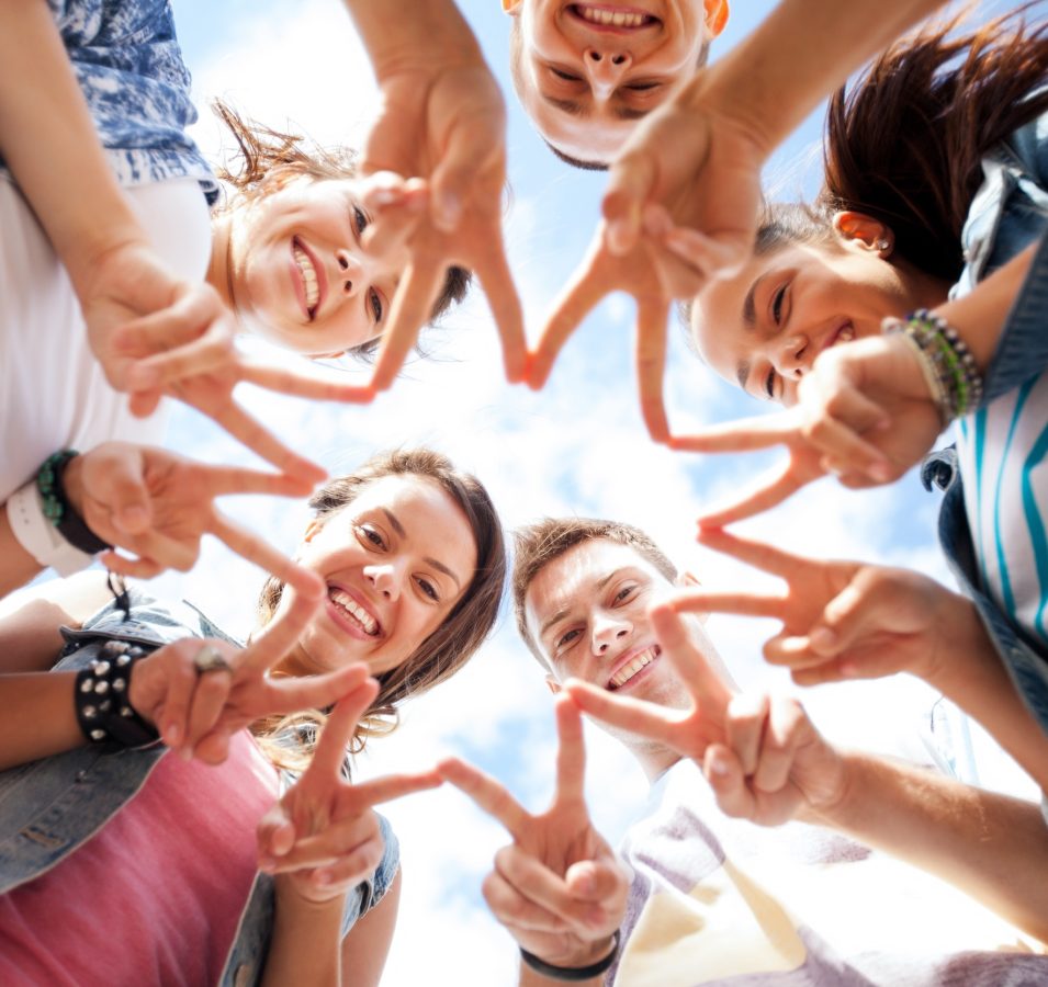 summer holidays and teenage concept - group of teenagers showing finger five gesture